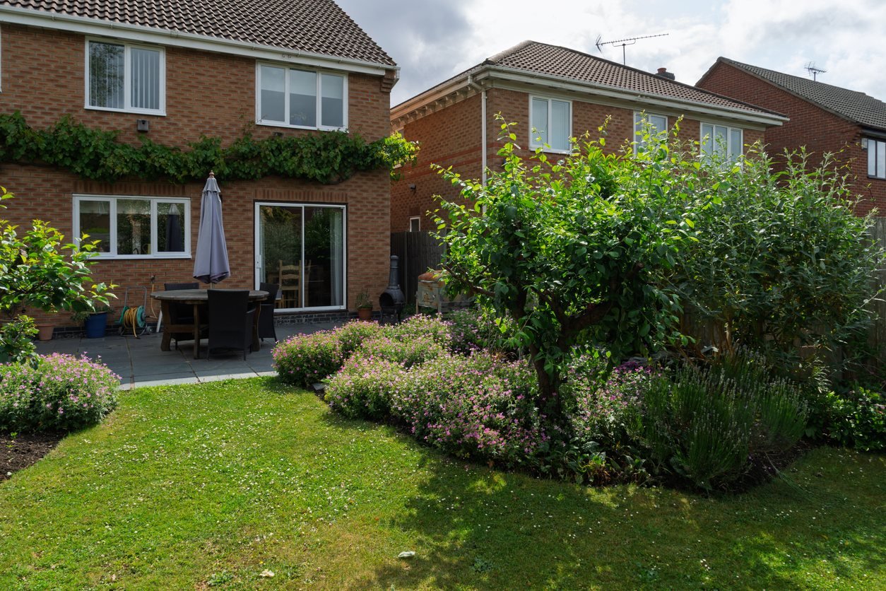 Residential garden with lawn and planted borders